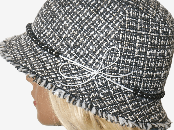 Black and white patterned hat with a decorative bow, close-up