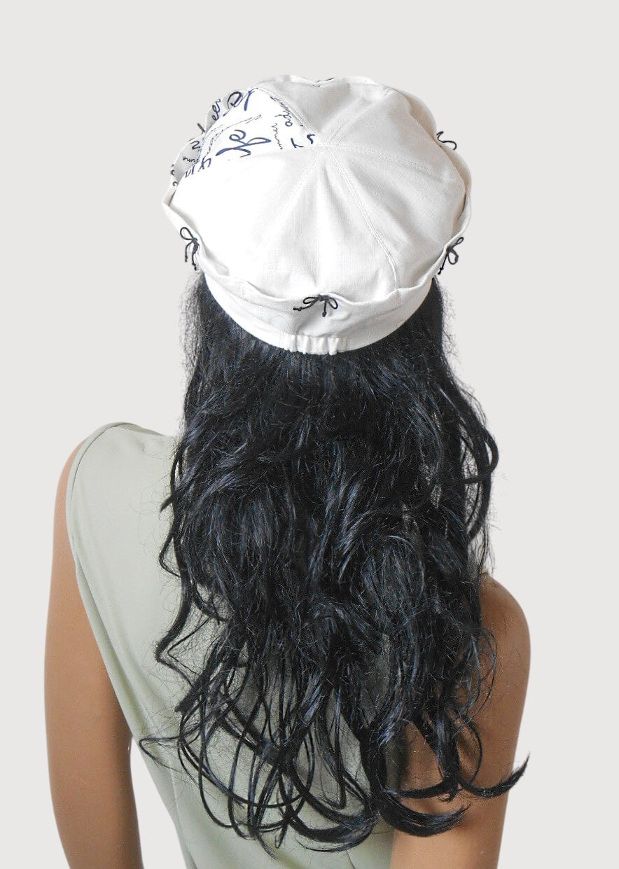 White linen cap with tiny black bows
