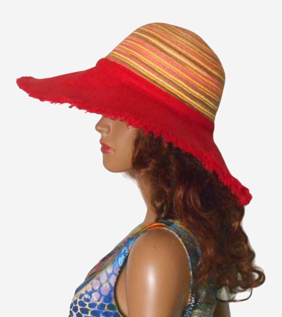 Head of a mannequin wearing a red sunhat with a multi-colored striped crown