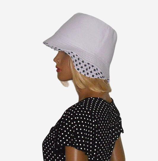 White linen hat with black polka dot accent