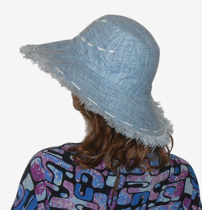 Back view of blue wide-brimmed linen hat with fringe-edged brim, deep side crease