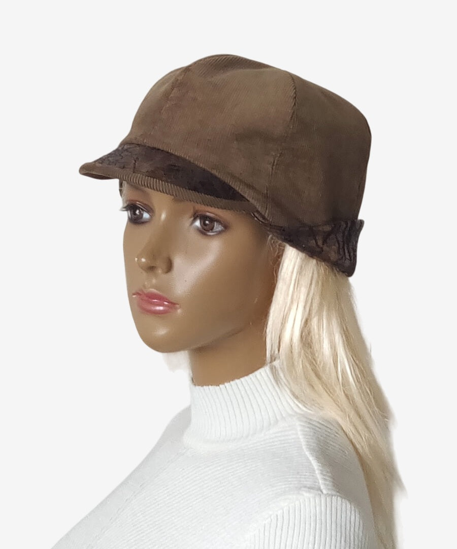 Angled view of brown corduroy jockey cap with leather details