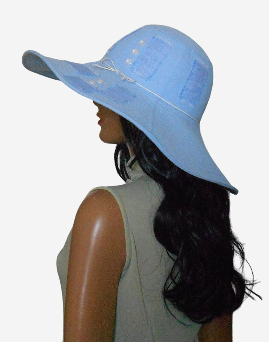 Light blue wide-brim sun hat, showing stylish design and sun protection, side view