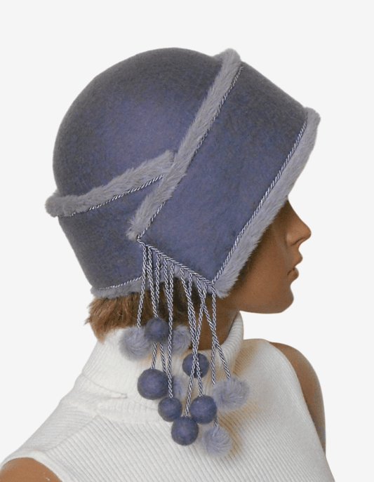 Side view of handmade lilac felted winter hat with playful pom-poms