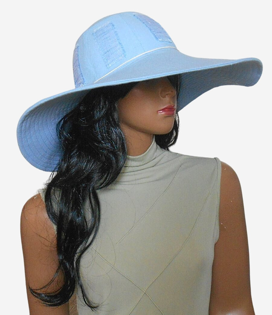 Three-quarter view of light blue wide-brim sun hat, perfect for beach and travel