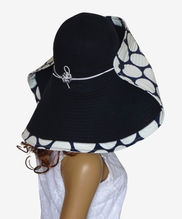 Back view of dark blue wide-brim asymmetric polka dot beach hat