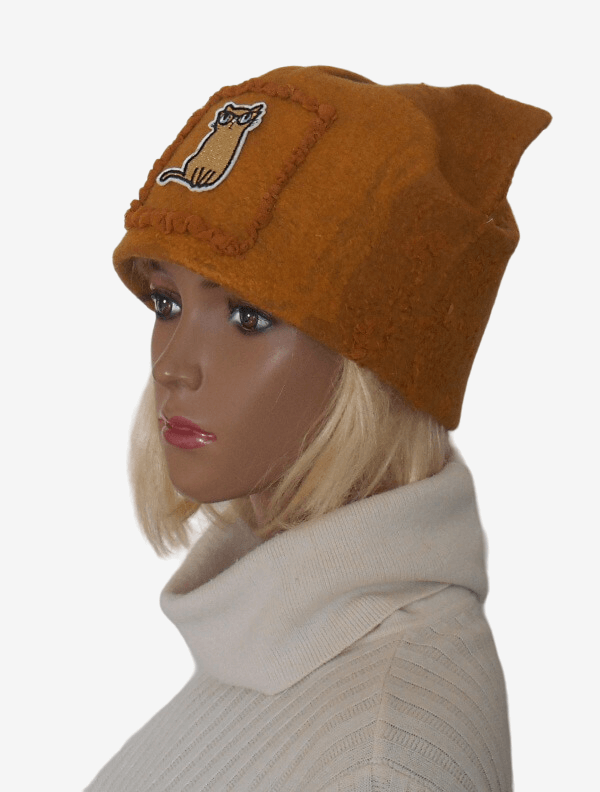 Three-quarter view of a yellow felt cat hat with cute cat ears.
