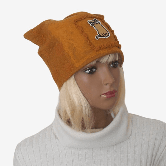 Three-quarter view of a cozy yellow felt cat hat with cat ears.