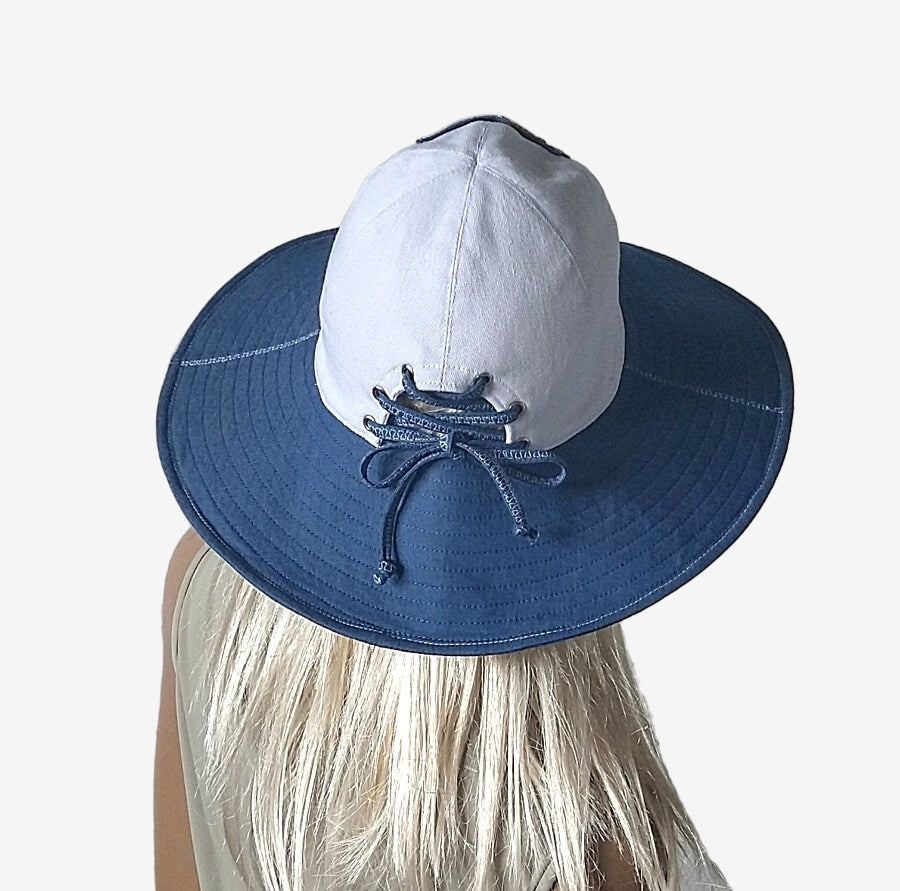 Back view of a wide-brimmed summer blue and white denim hat