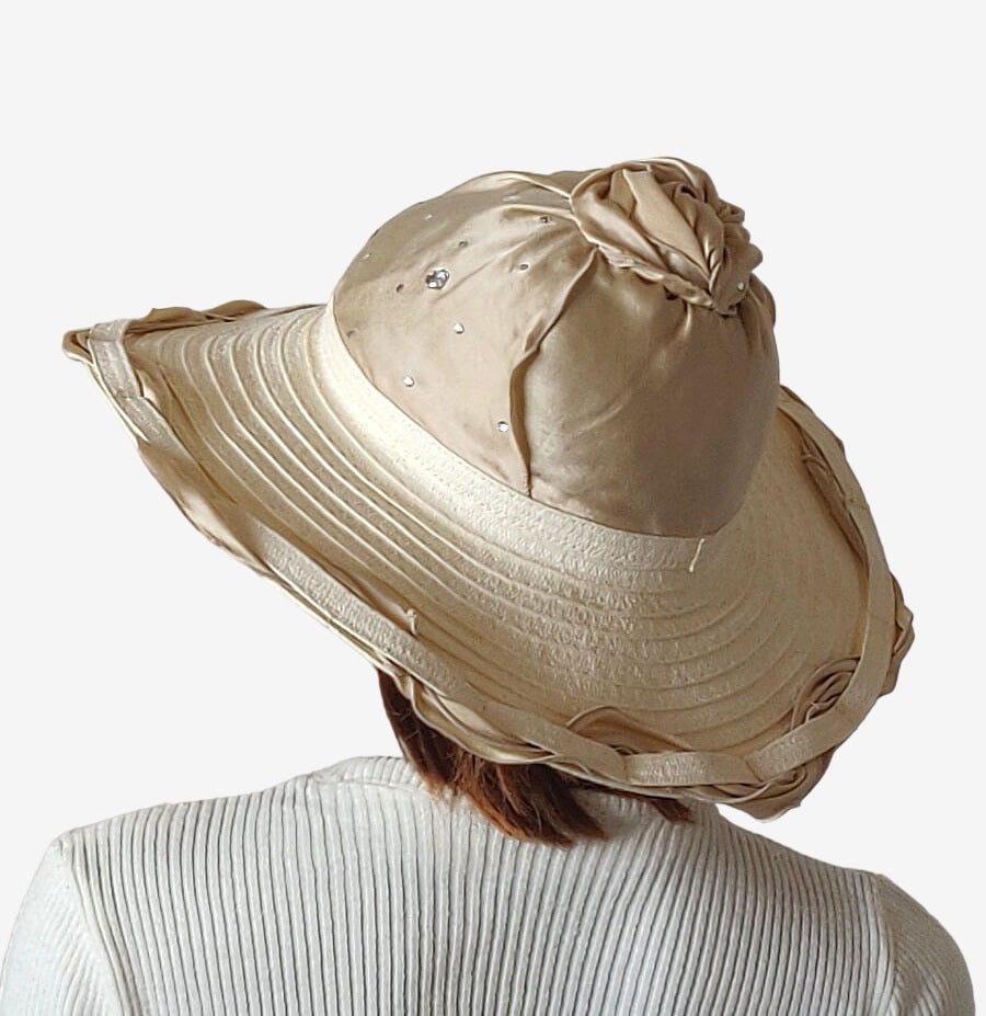 Back view of beige beach hat showing silk crown and decorative details