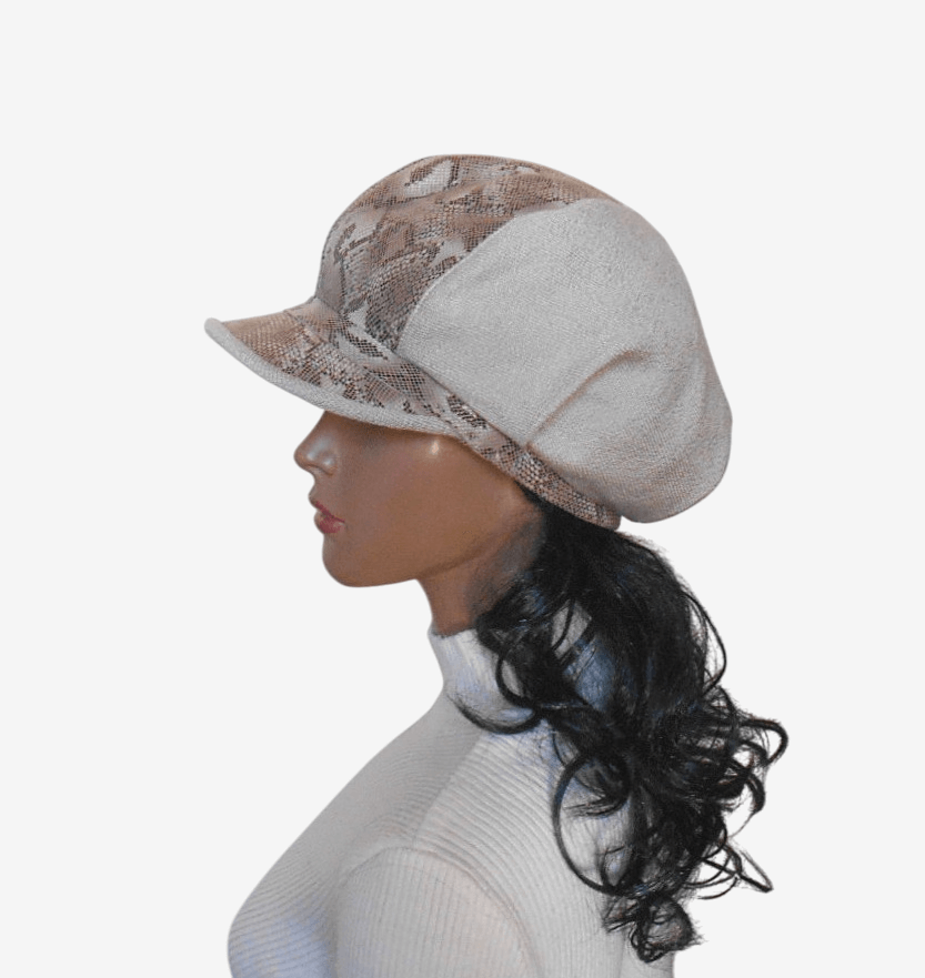Side view of beige cap showing pleats and leather visor with snake pattern