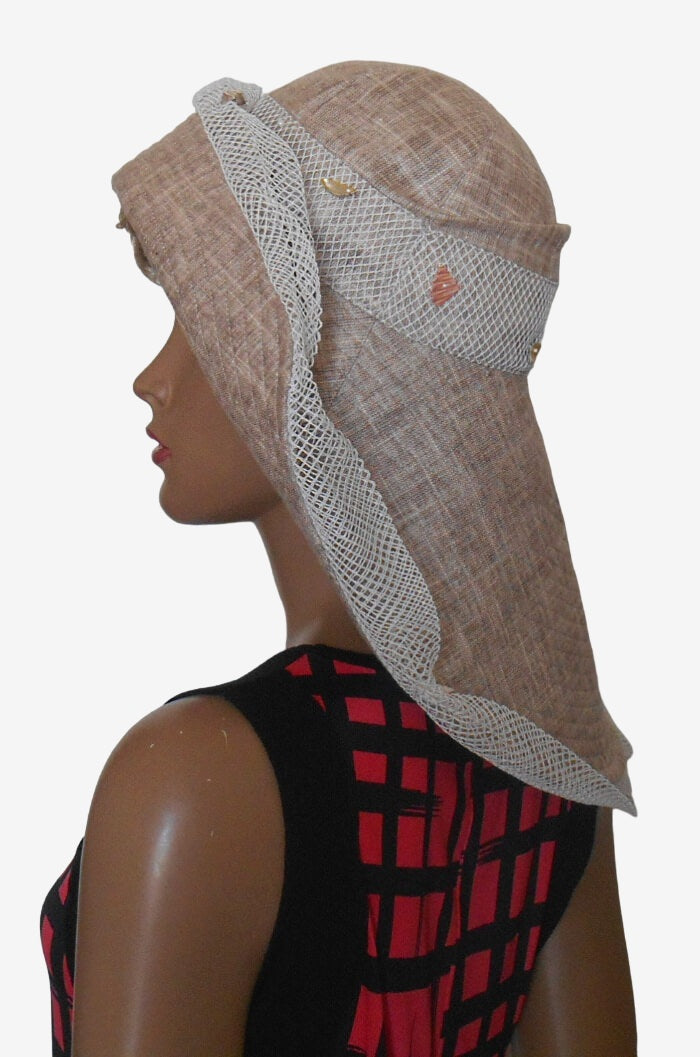 Side view of beige linen sun hat with wide asymmetrical brim