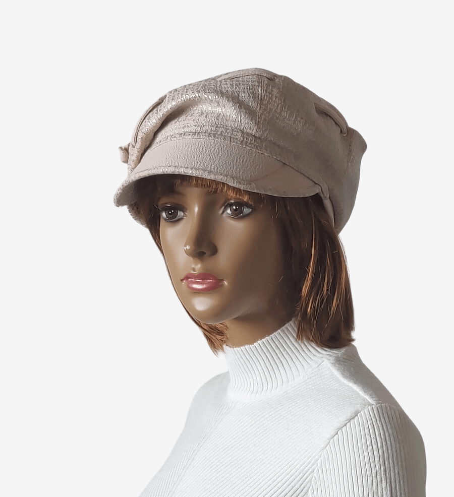 Three-quarter view of a beige newsboy cap