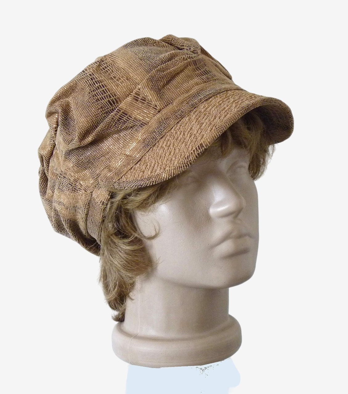 Three-quarter view of beige corduroy newsboy cap with draped top