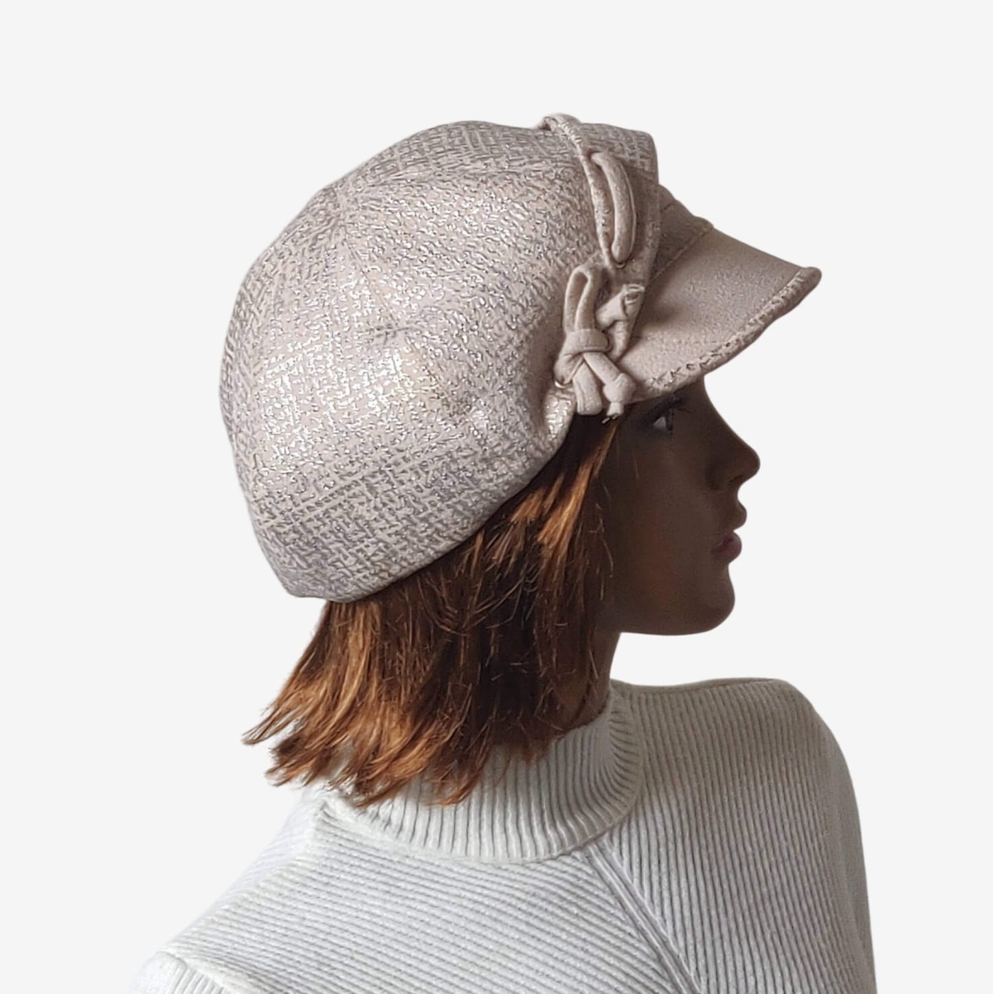 Side view of beige newsboy cap