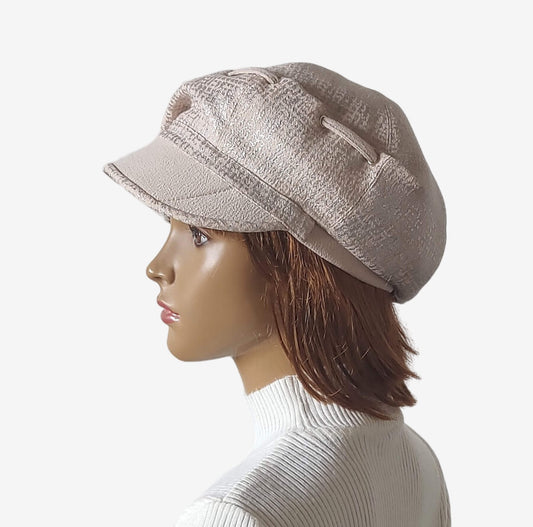 Beige women’s newsboy cap with deep front crease detail