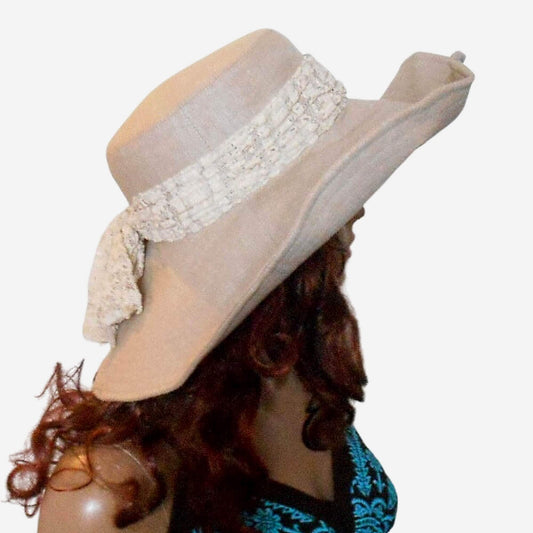 A beige wide-brimmed linen hat with a lace fabric bow 