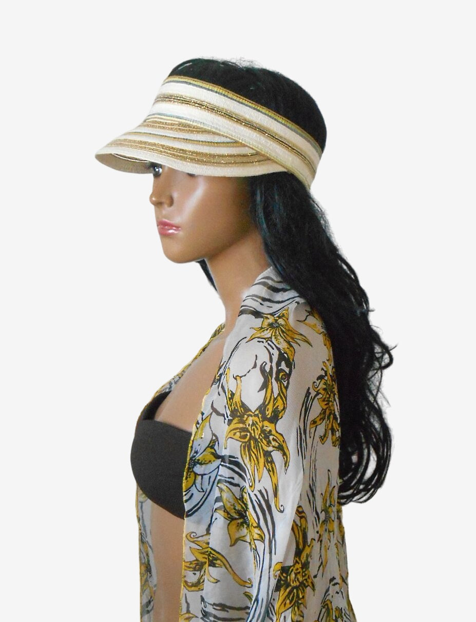 Three-quarter view of beige yellow beach visor and silk pareo scarf set, showing the visor shape and pareo pattern