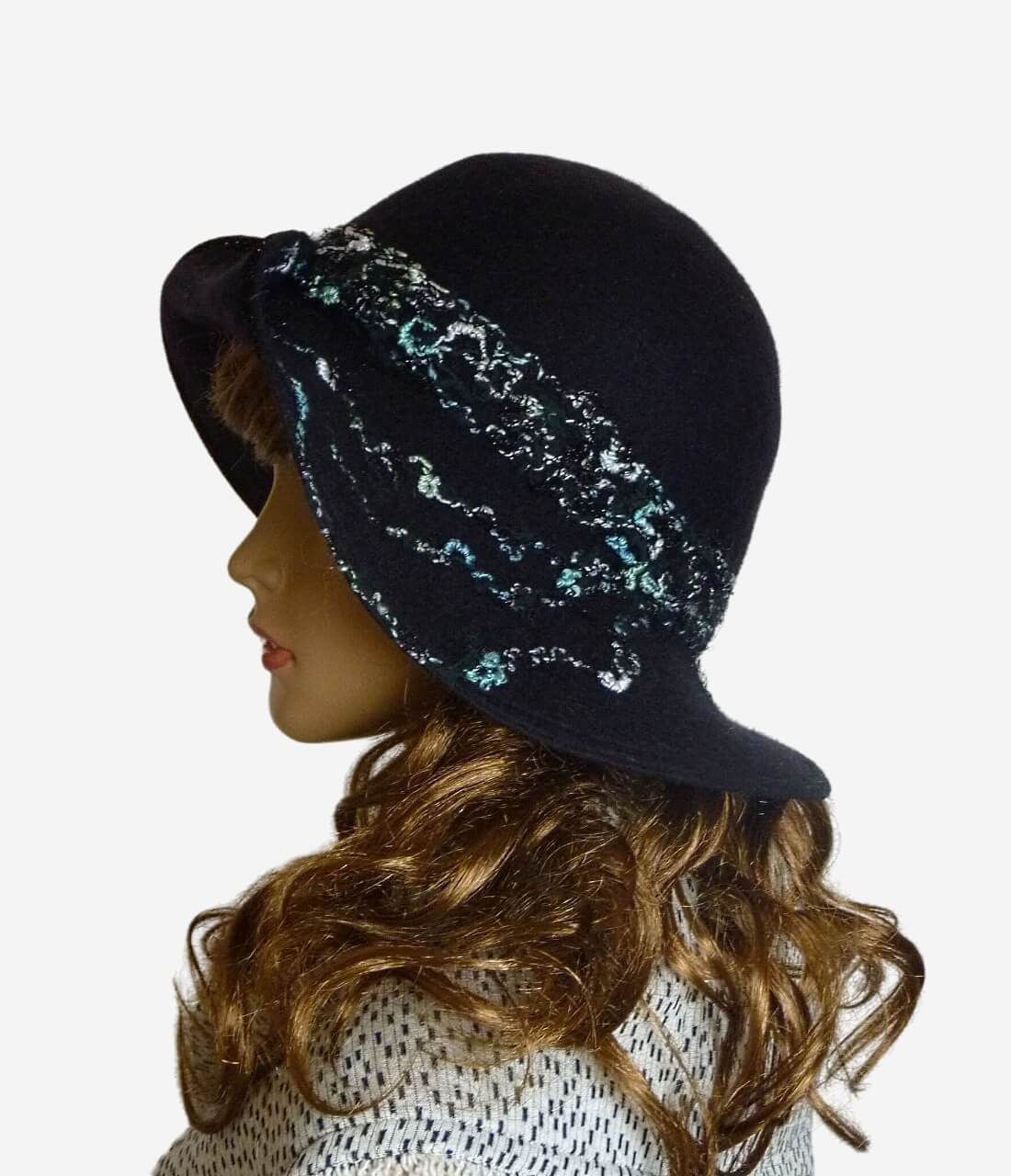 Side view of black felted wool hat with textured multicolored threads and medium brim