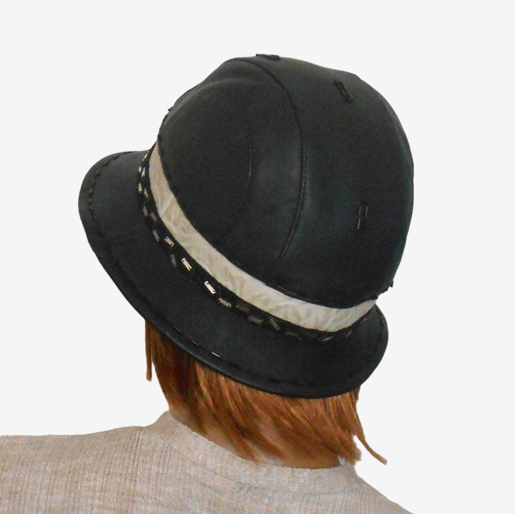 Back view of a women’s black leather hat showing narrow brim and warm lining