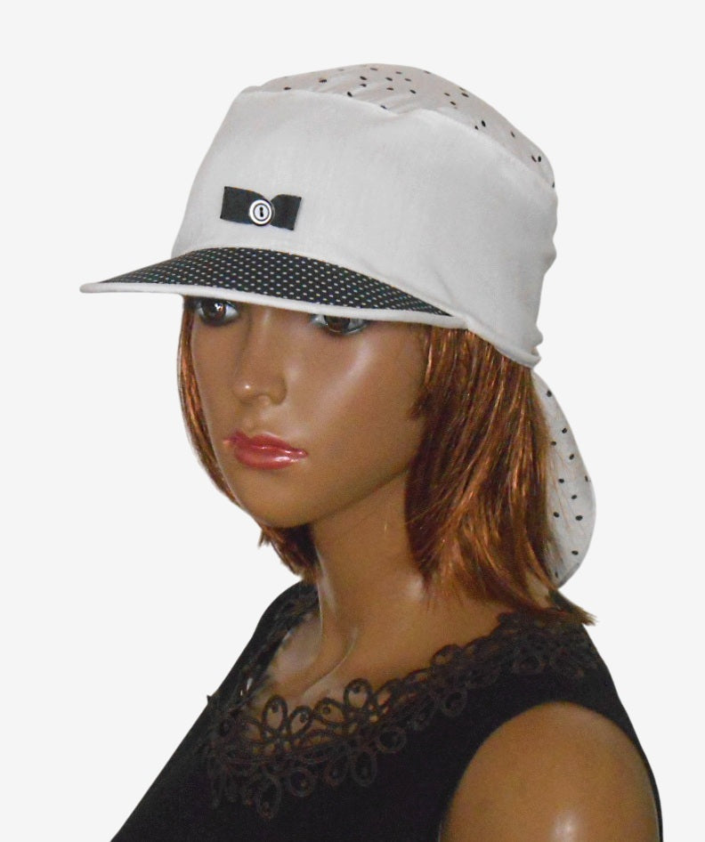 Three-quarter view of black and white polka dot visor bandana showing playful bow