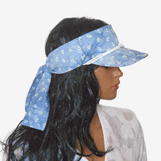 A woman's head wearing a blue sun visor with a nautical pattern, featuring a ties for adjustment.
