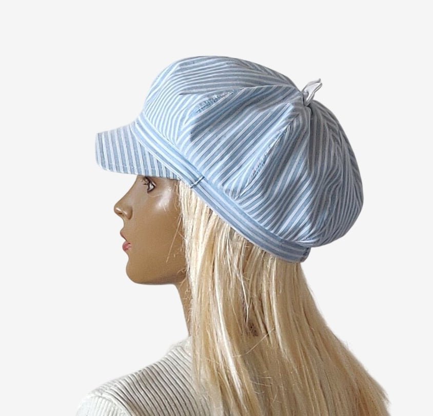 Blue and white striped summer newsboy cap with bow, side view left
