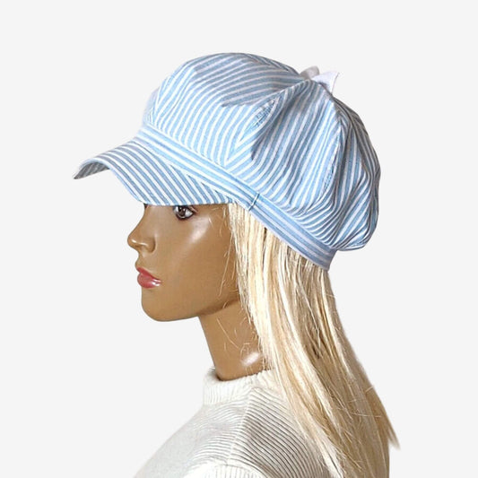 Blue and white striped newspaper cap with a small asymmetrical peak and a bow