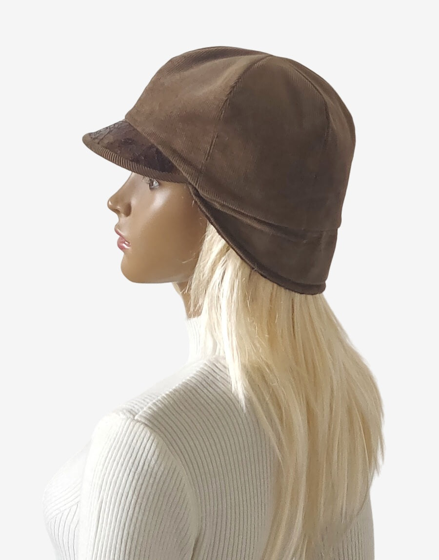 Brown corduroy jockey cap with leather lapel lowered to cover ears