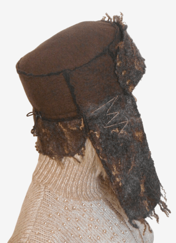 Side view of brown felted trapper hat with ear flaps