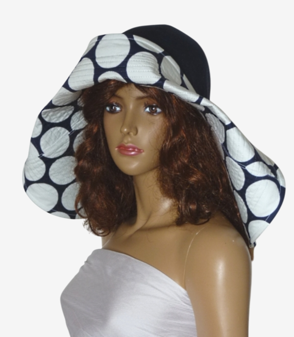 Dark blue asymmetric wide-brim beach hat with polka dots, three-quarter view