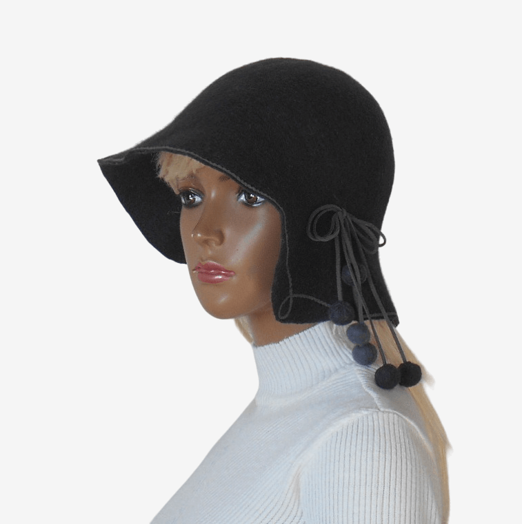 Three quarter view of dark gray felt hat with pom-poms, stylish women’s winter hat