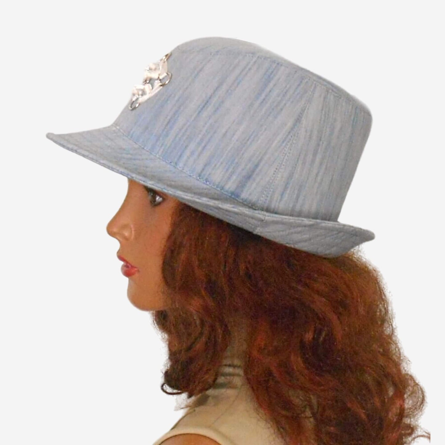 A denim blue trilby hat with a small brim
