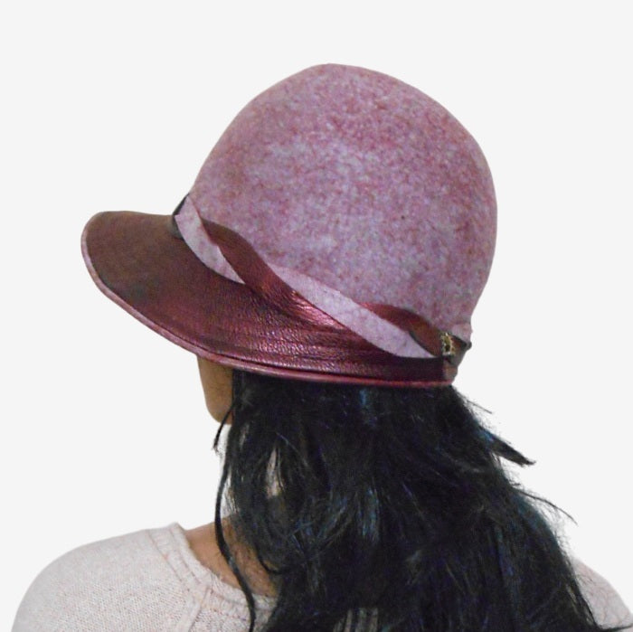 Back view of a felted lilac burgundy hat with a brim