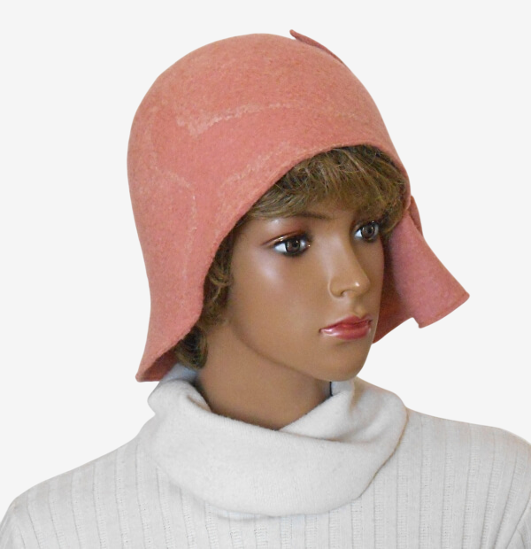 Three-quarter view of stylish women’s felted pink hat with asymmetrical brim 