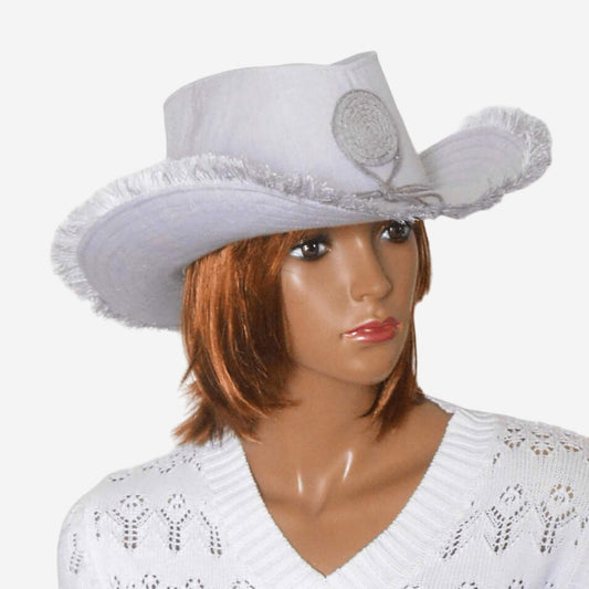 A gray linen cowboy hat with fringe displayed on a female mannequin 