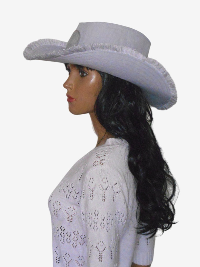 Side view of gray linen cowboy hat with decorative front detail and fringed trim