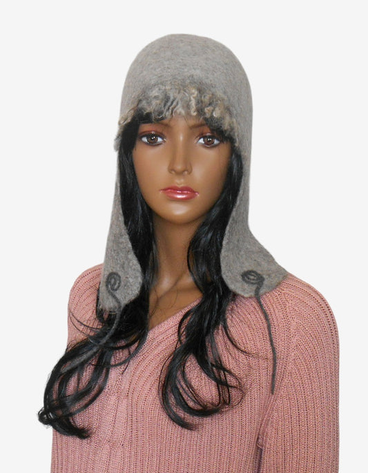 Front view of gray felted wool women’s ear flap hat with decorative wool curls and warm lining