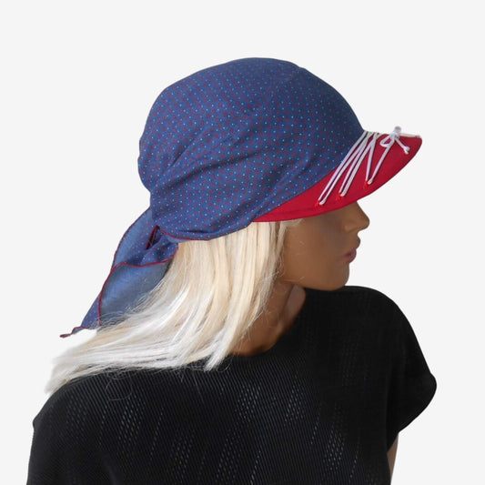 A blue denim bandana with a red visor and white polka dots, tied around the head.
