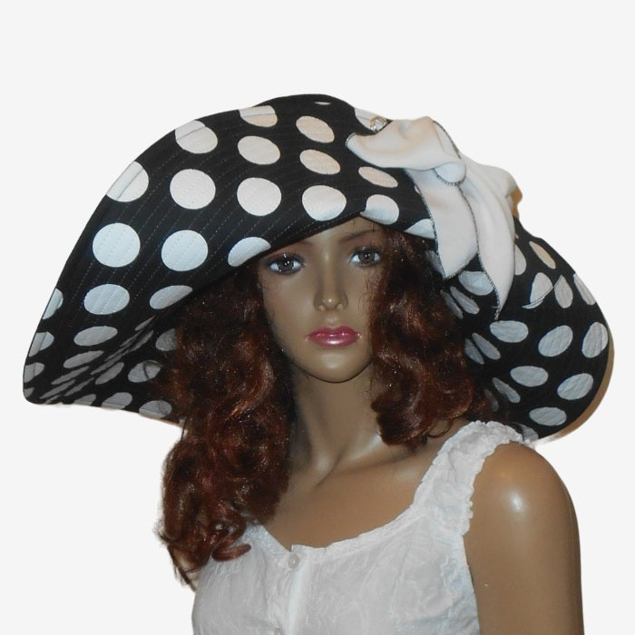 Front view of black and white polka dot wide brim sun hat