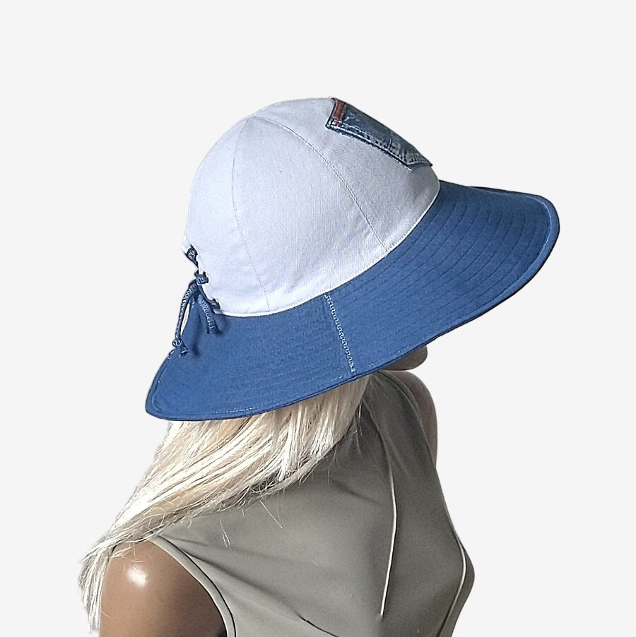 A side view of a wide-brim blue and white denim summer hat