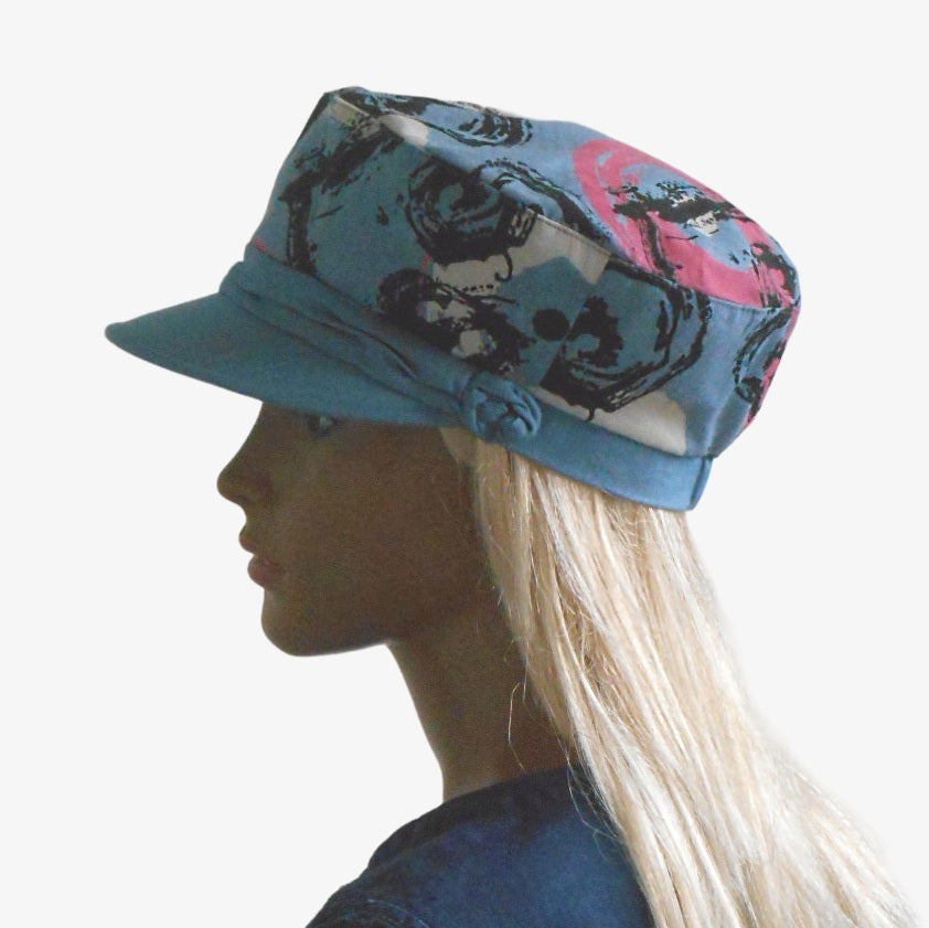 Women’s summer denim captain’s cap with abstract pattern and draped detail, side view