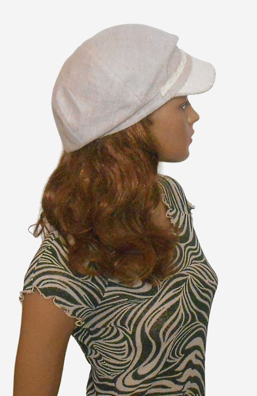 Womens beige linen newsboy cap showing white side panel and button, side view