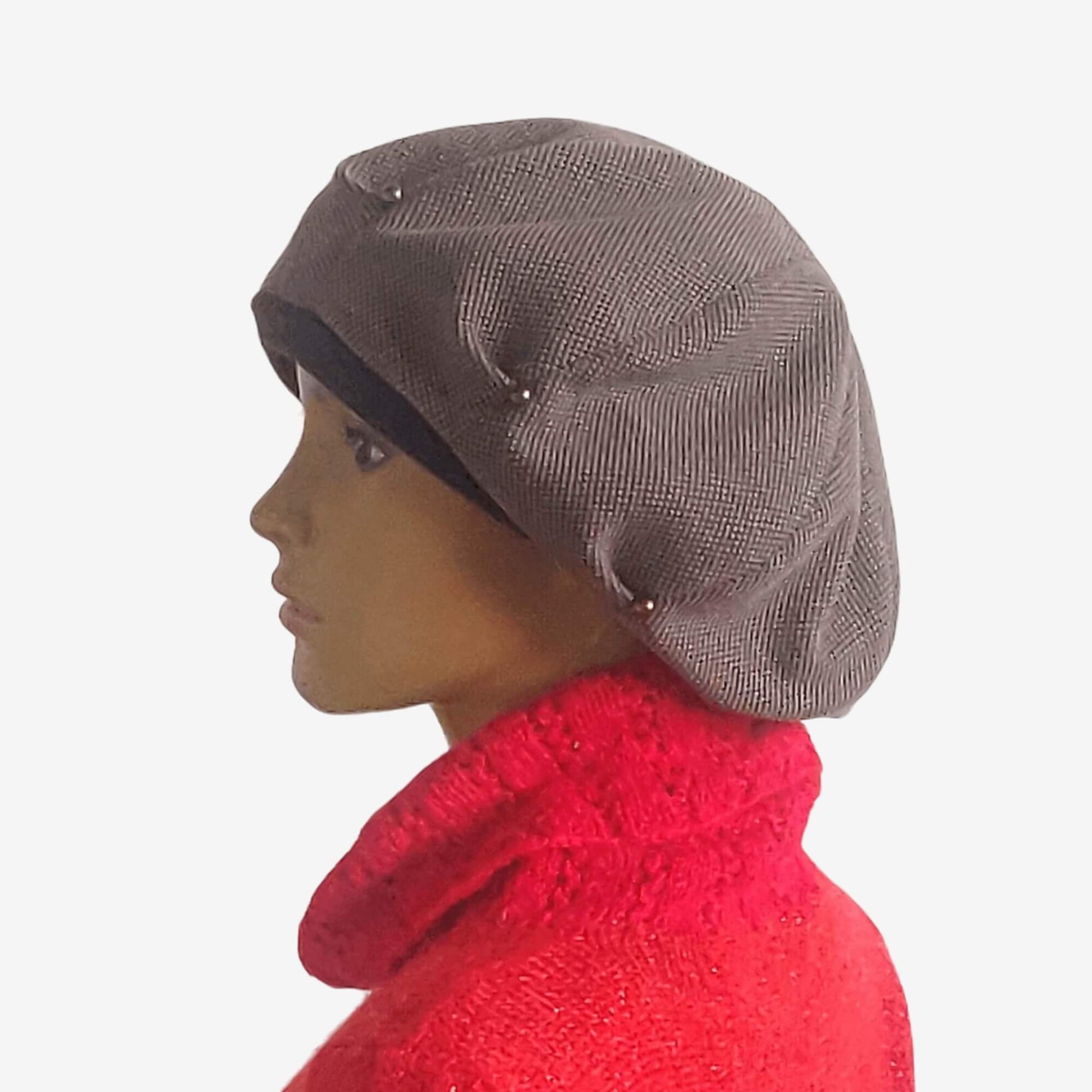 Slouchy oversized brown beret with decorative beads.
