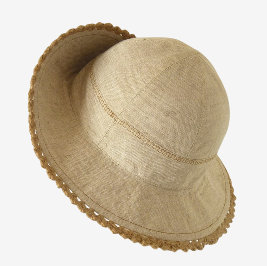Three-quarter view of linen summer hat, showing small brim and handcrafted details