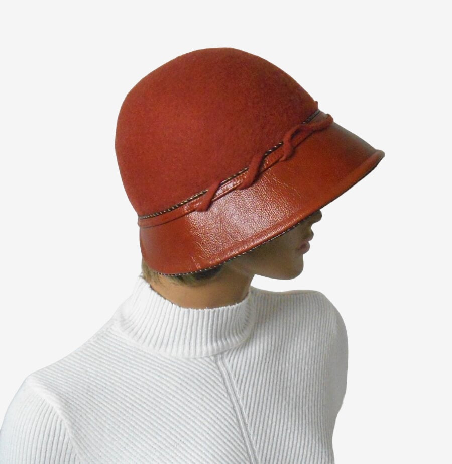 Side view of terracotta felt and leather hat