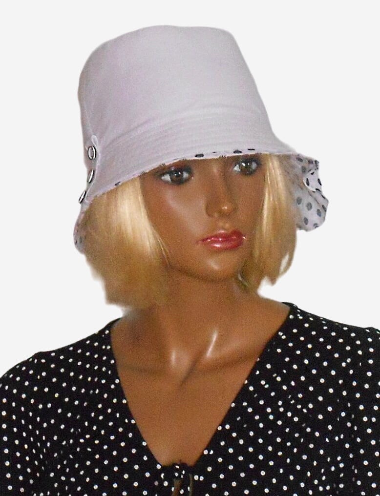 Front view of women’s white linen summer hat with polka dot accent
