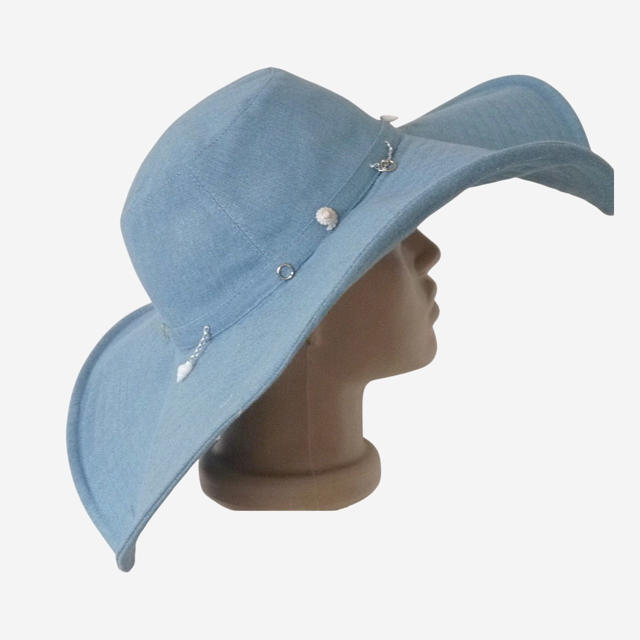 Side view of wide-brim denim hat showing decorative details