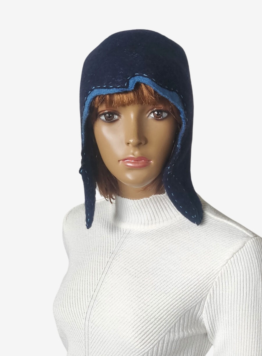 Front view of a dark blue winter hat with earflaps for warmth and style