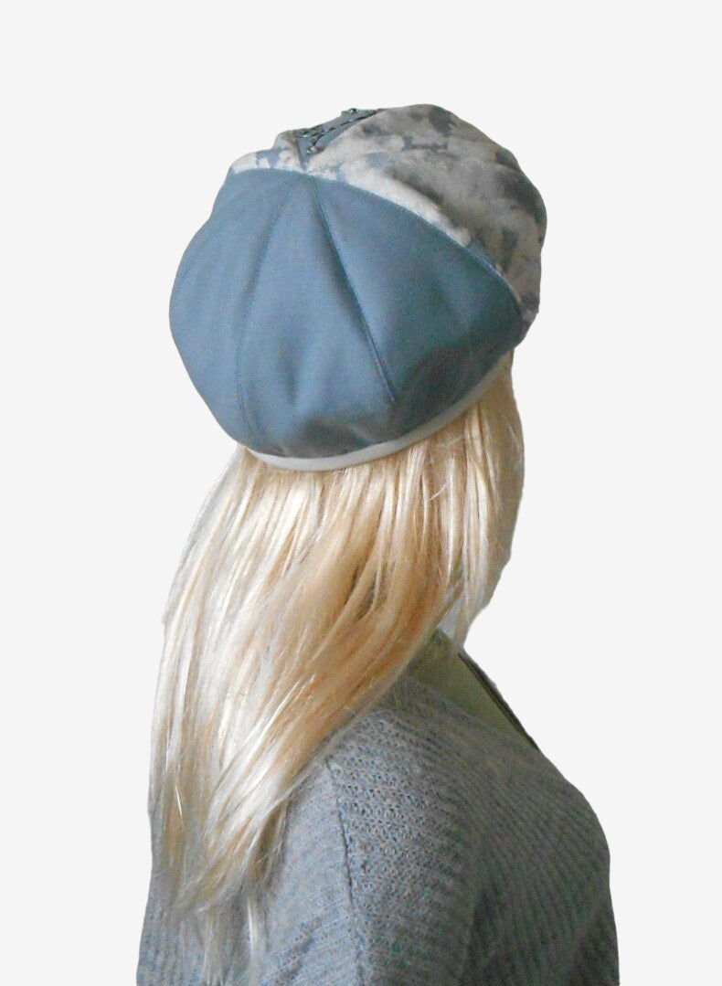 Back view of women’s blue and white beret made from faux fur and wool